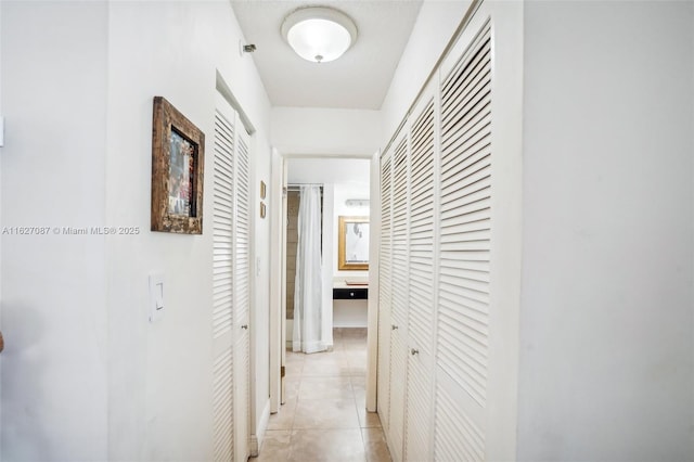 corridor featuring light tile patterned flooring