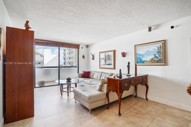 living area with a textured ceiling and baseboards