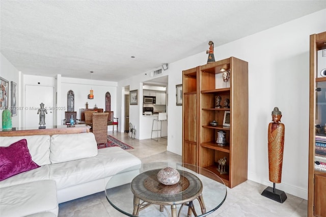 living room featuring a textured ceiling