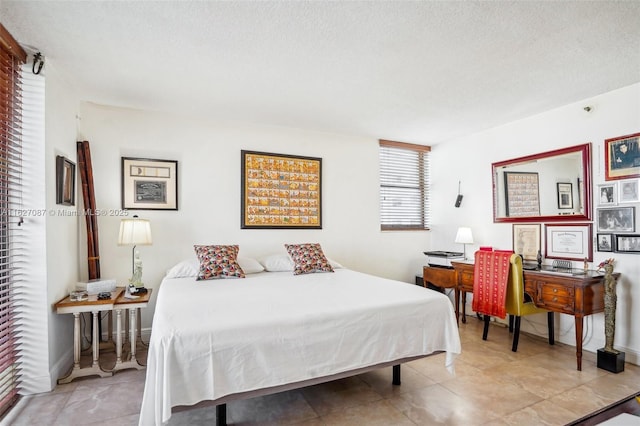 tiled bedroom featuring a textured ceiling