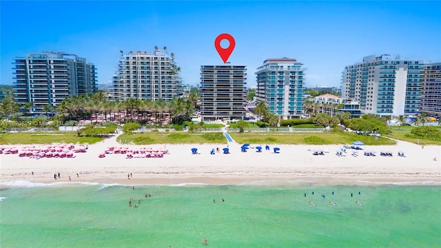 drone / aerial view with a water view and a beach view