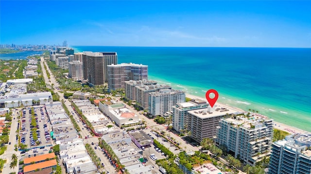 drone / aerial view with a water view and a beach view