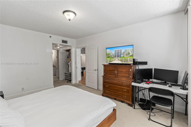 carpeted bedroom with a textured ceiling