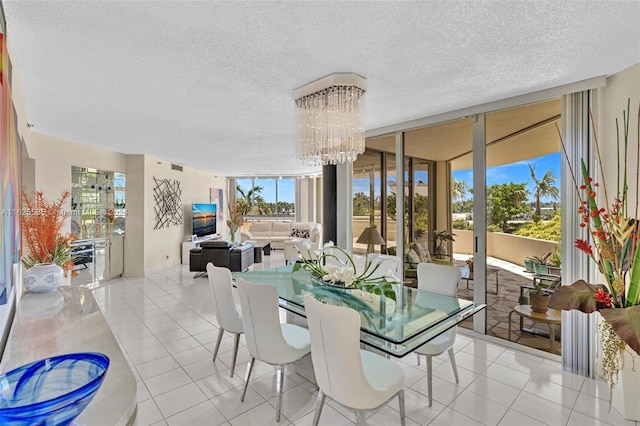 tiled dining space with an inviting chandelier, a textured ceiling, and expansive windows