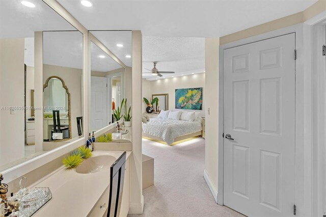 bathroom with vanity, a textured ceiling, and ceiling fan