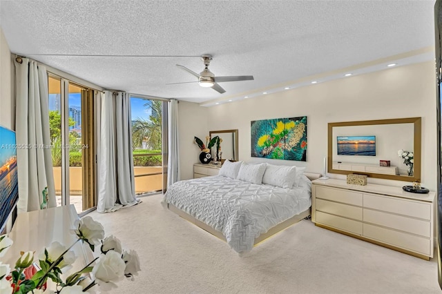 carpeted bedroom featuring multiple windows, ceiling fan, and access to exterior