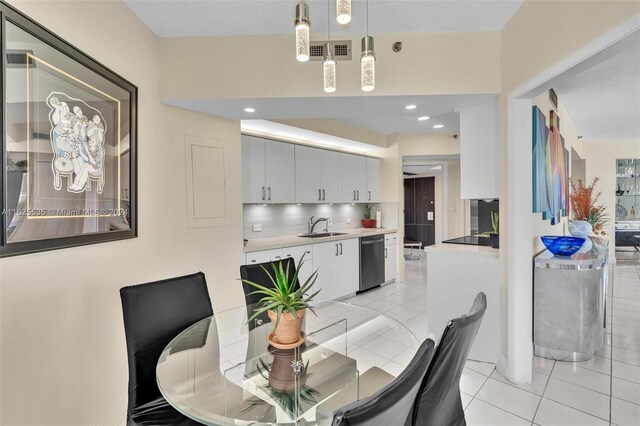 tiled dining space featuring sink