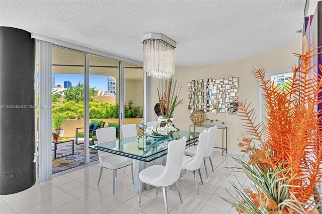 dining area with light tile patterned flooring, a textured ceiling, and plenty of natural light