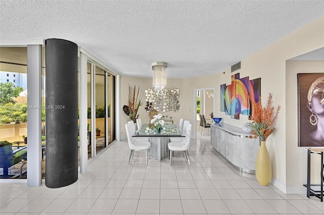 dining room featuring a textured ceiling, light tile patterned floors, and a chandelier