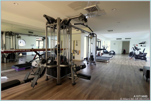 exercise room with hardwood / wood-style flooring