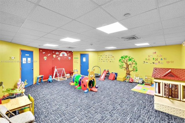 game room featuring a drop ceiling and carpet