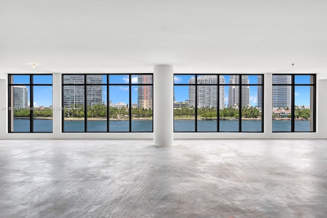 interior space featuring a water view and concrete flooring