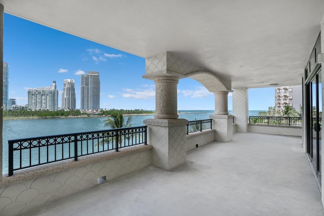 view of patio / terrace featuring a water view and a balcony