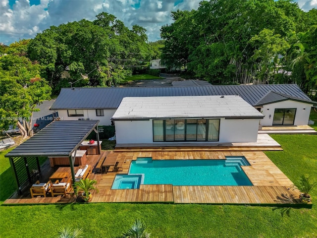 7000 SW 125th St, Pinecrest, FL 33156 - back of house with a wooden deck, stucco siding, a lawn, and a pool with connected hot tub