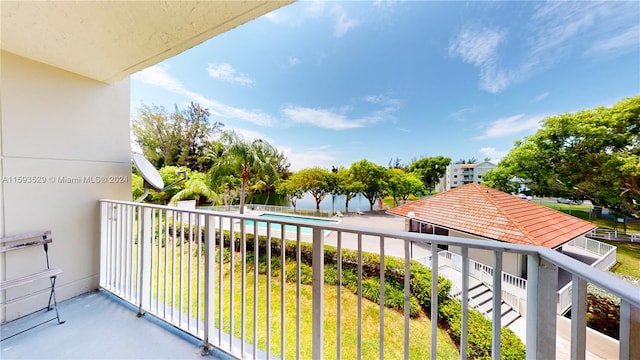 balcony featuring a fenced in pool