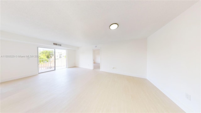 spare room with light wood-type flooring