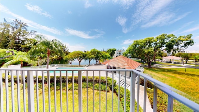 view of swimming pool with a lawn