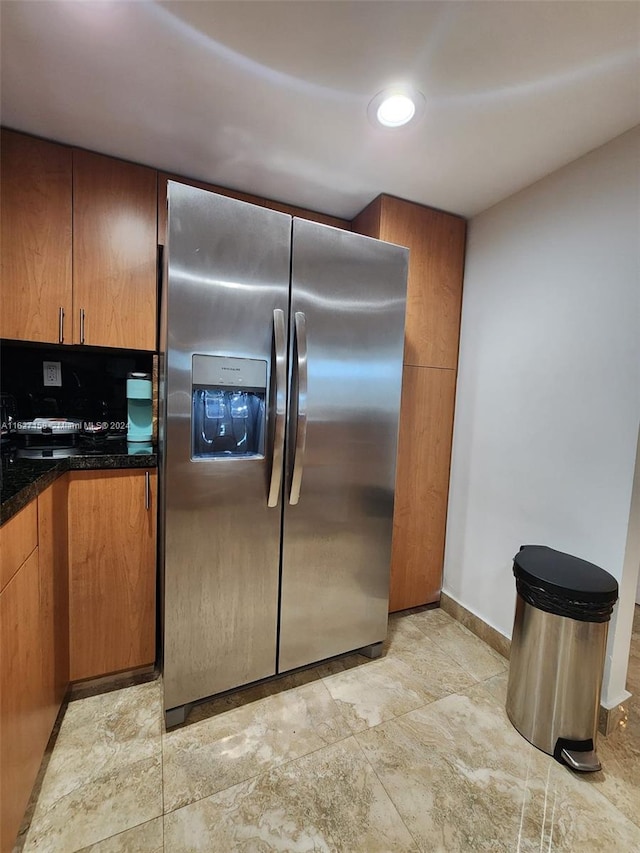 kitchen with light tile patterned flooring and stainless steel refrigerator with ice dispenser