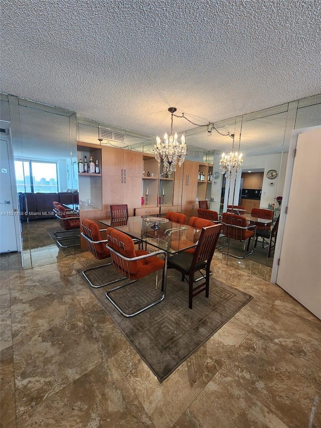 tiled dining space with a notable chandelier and a textured ceiling