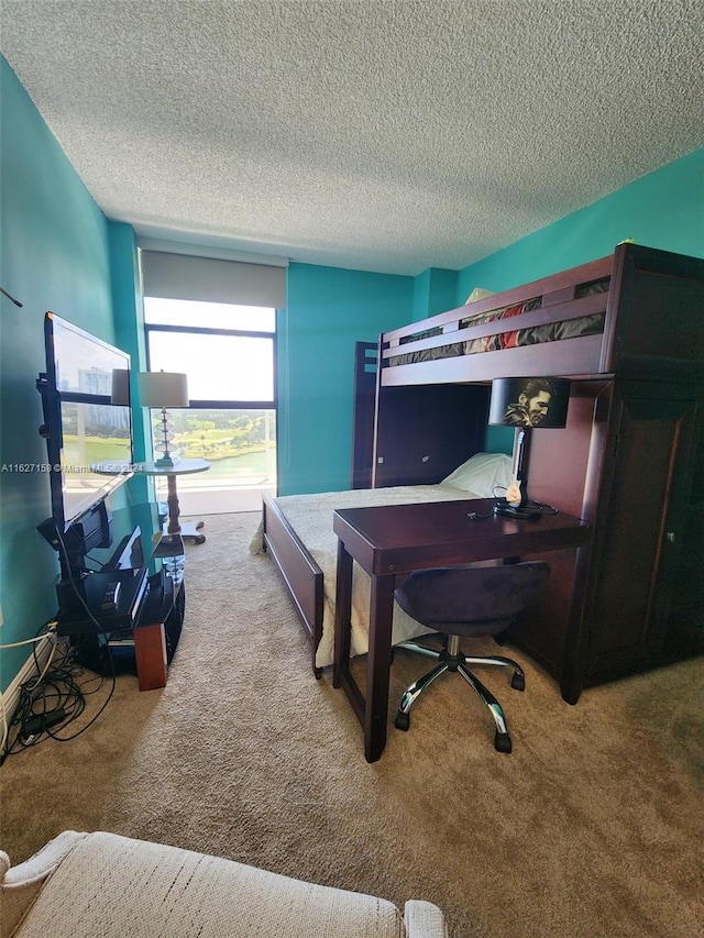 carpeted bedroom with a textured ceiling