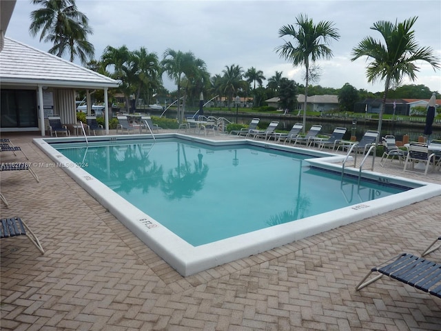 pool featuring a patio area and fence