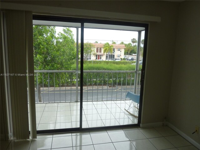 doorway to outside featuring light tile patterned flooring