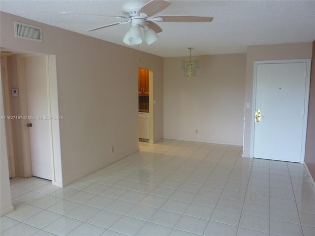 unfurnished room with light tile patterned floors and ceiling fan