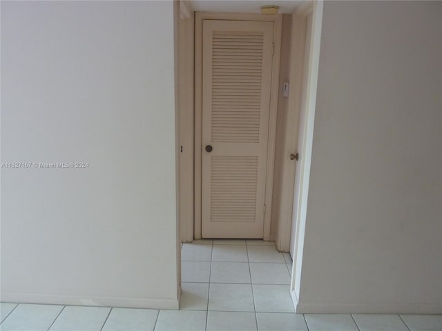 corridor featuring light tile patterned floors