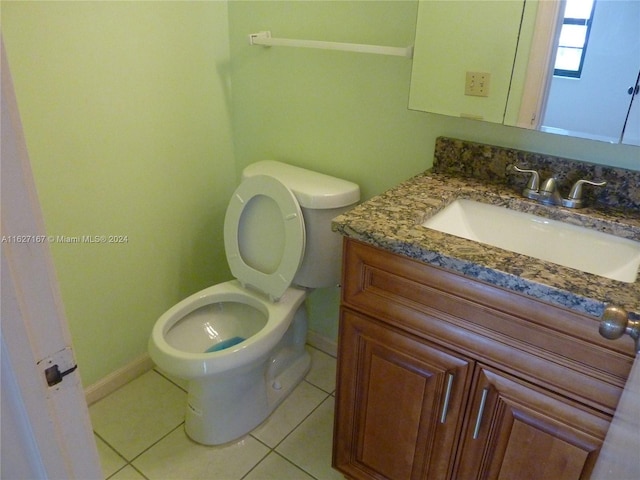 bathroom with vanity, toilet, and tile patterned floors