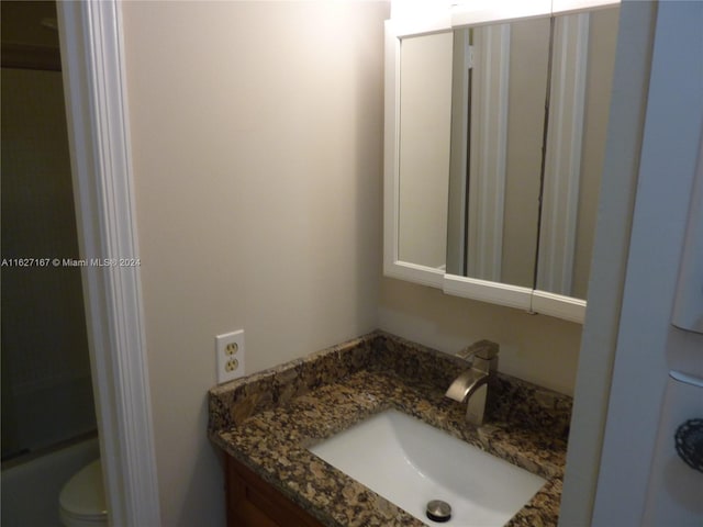 bathroom with toilet and vanity