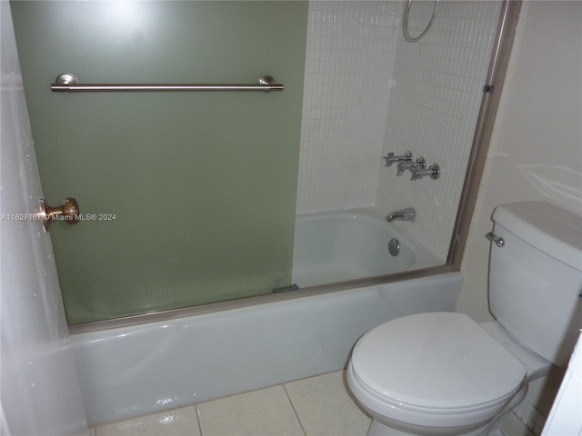 bathroom with toilet, combined bath / shower with glass door, and tile patterned flooring