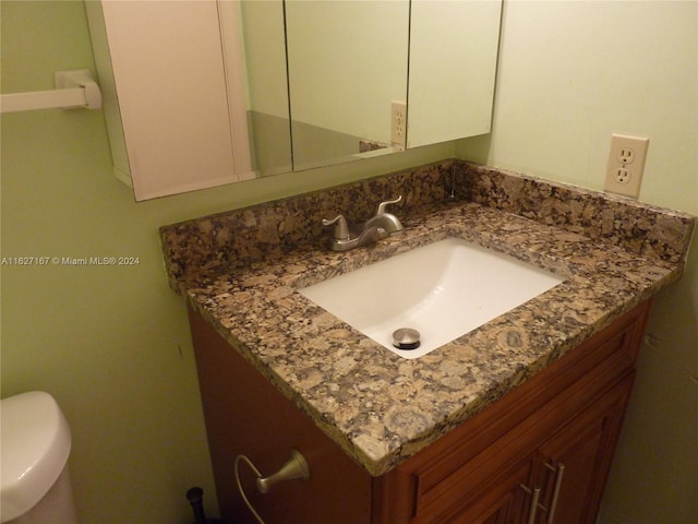 bathroom with toilet and vanity