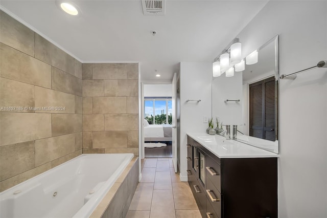 bathroom featuring vanity, tiled bath, and tile patterned flooring