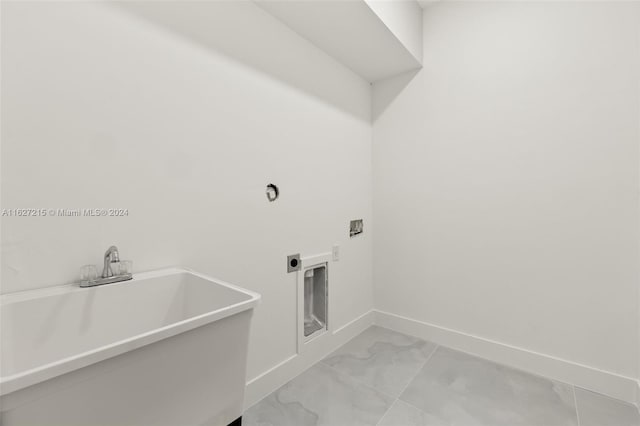 laundry room featuring electric dryer hookup, sink, tile patterned flooring, and washer hookup