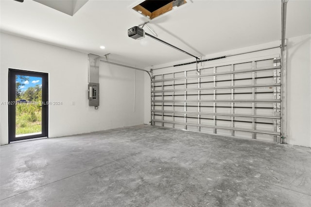 garage with electric panel and a garage door opener