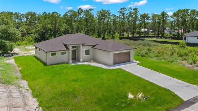 view of front of property featuring a garage and a front lawn