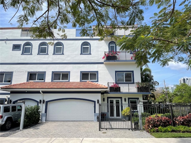 view of front facade featuring a balcony and a garage