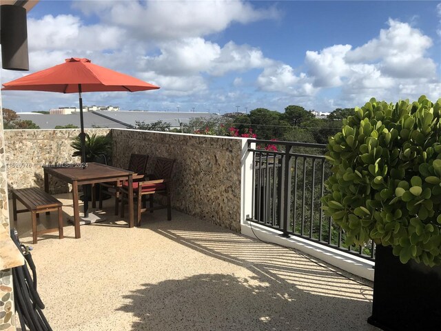 645 NE 9th Ave, Fort Lauderdale, FL 33304 - view of patio / terrace with a balcony, outdoor dining space, and a water view