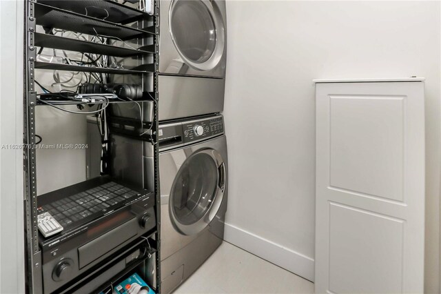 645 NE 9th Ave, Fort Lauderdale, FL 33304 - washroom with stacked washer and clothes dryer and baseboards