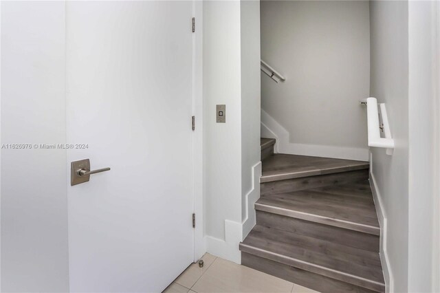 645 NE 9th Ave, Fort Lauderdale, FL 33304 - staircase with baseboards and tile patterned flooring