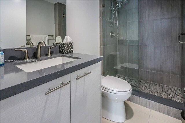645 NE 9th Ave, Fort Lauderdale, FL 33304 - bathroom featuring toilet, a shower stall, vanity, and tile patterned floors