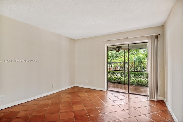 tiled empty room featuring ceiling fan and a textured ceiling