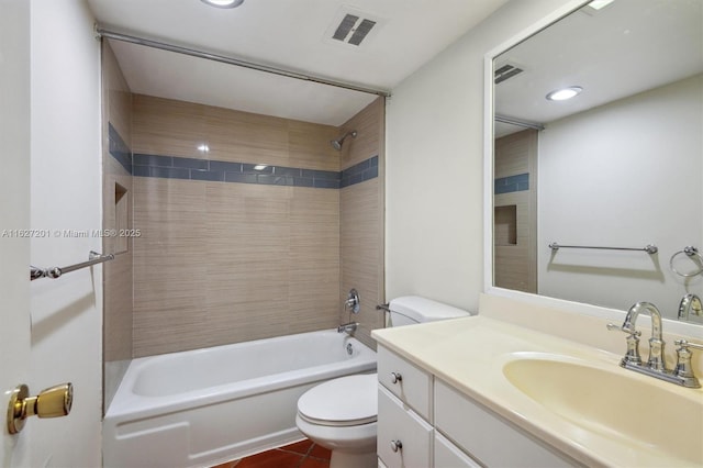 full bathroom featuring tiled shower / bath, vanity, and toilet