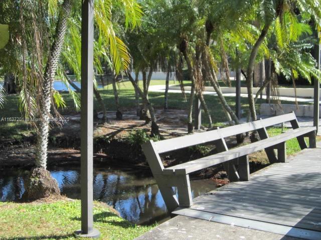 view of home's community with a boat dock and a water view