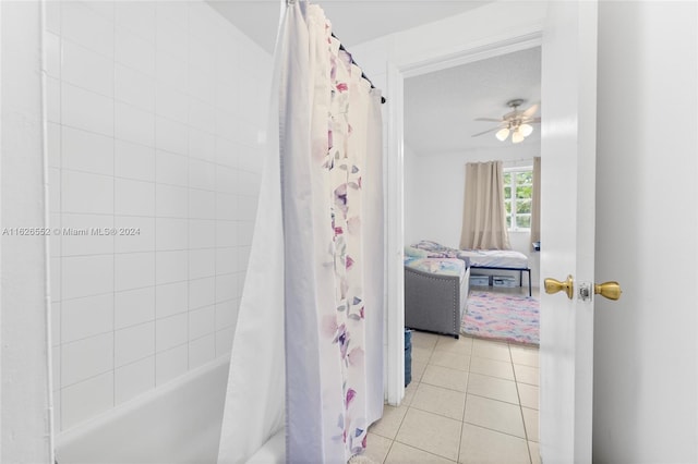 bathroom with tile patterned floors, shower / tub combo with curtain, and ceiling fan