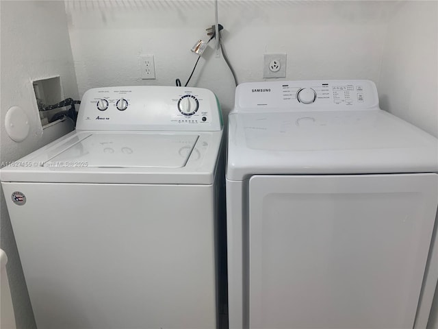 clothes washing area with washer and dryer