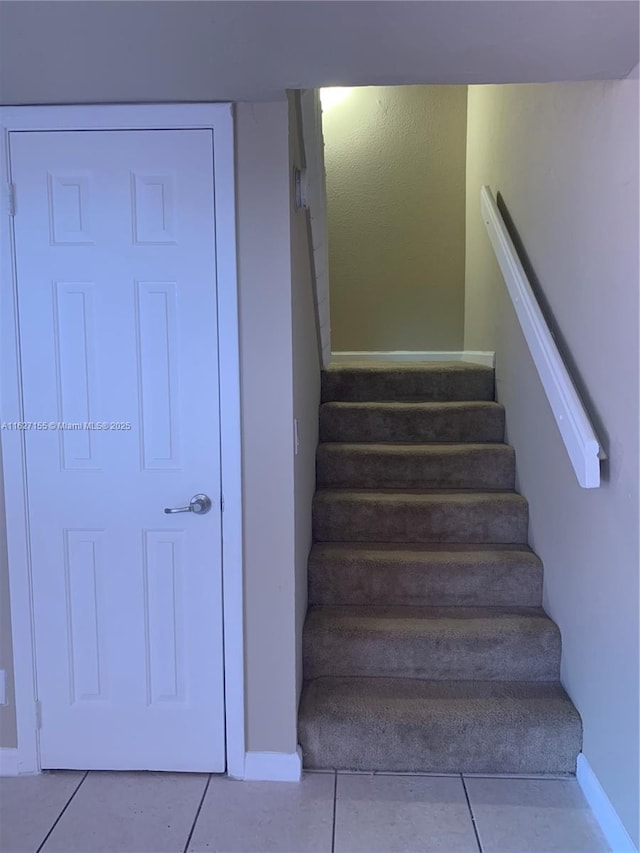 stairs with tile patterned floors