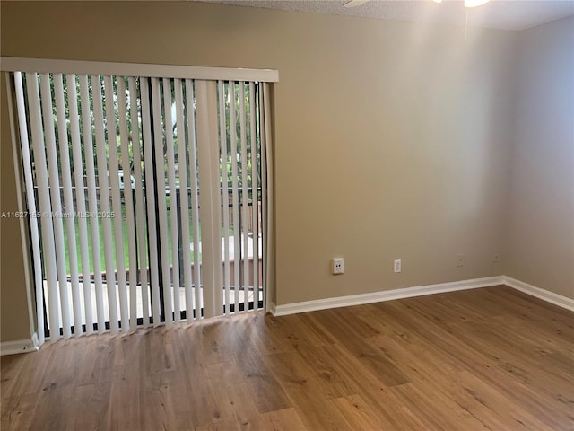 empty room featuring ceiling fan and light hardwood / wood-style floors