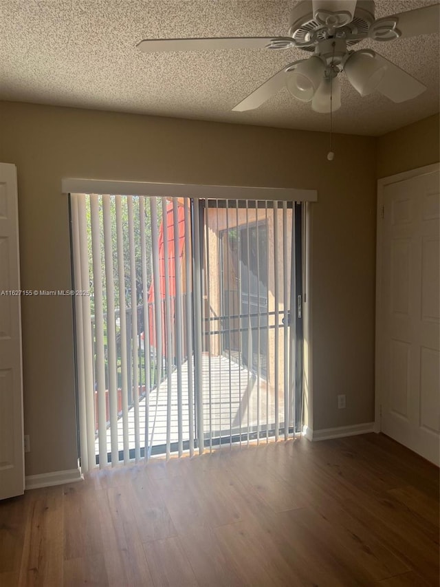 unfurnished room with ceiling fan, hardwood / wood-style floors, and a textured ceiling