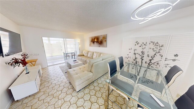 living room with light tile patterned flooring and a textured ceiling